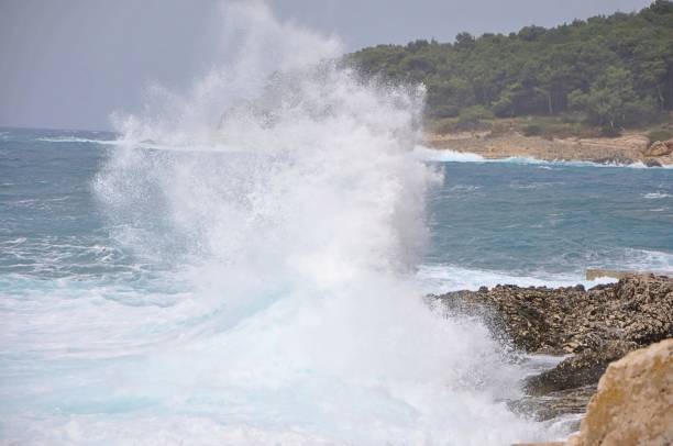istock Wave splash in the ocean against beach reef, Wave splash. Powerful Waves on a rocky beach.Waves crushing into the rocks, Island Losinj, Croatia 1463688220
