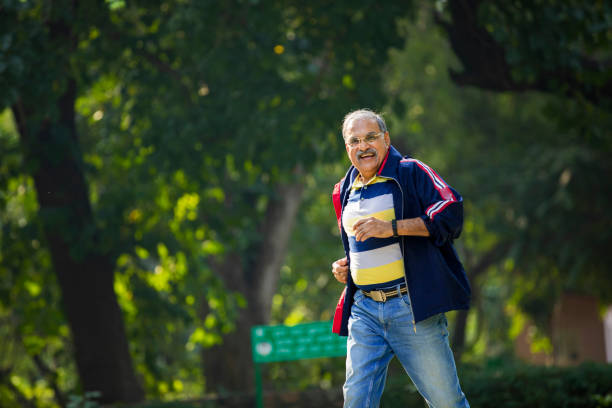 vecchio indiano che corre o fa jogging al parco - old man of coniston foto e immagini stock