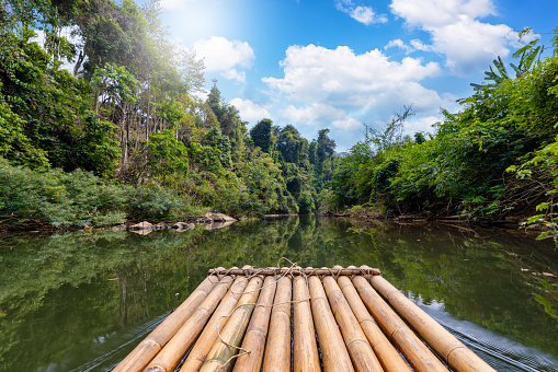 First person view of a bamboo float in a river cruise adventure in the Khao Sok national park, Thailand