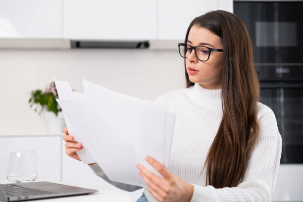 istock Serious millennial girl in modern glasses working with documents 1463690883