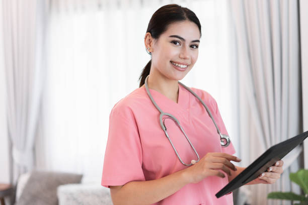 istock Beautiful caucasian nurse holding tablet computer at home 1463690912