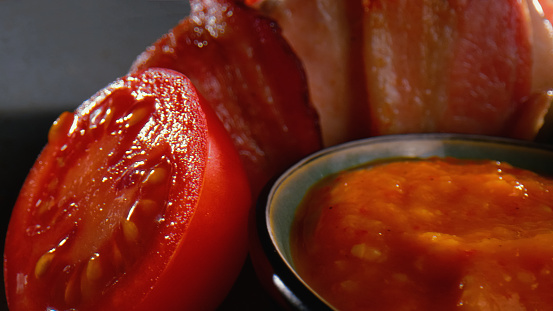 Vegetable sauce, ham and half of tomato - close up