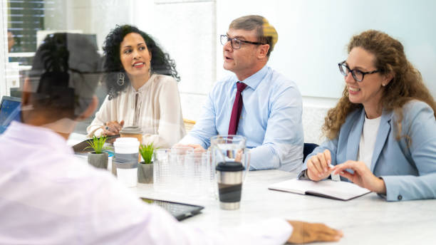 istock Smiling colleagues brainstorming in morning briefing 1463692372