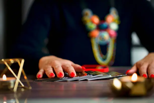 Photo of Blurred Tarot cards, Fortune telling on tarot cards magic crystal, occultism, Esoteric background. Fortune telling,tarot predictions.