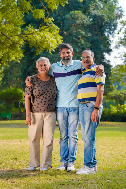 Young Indian man with his parents at park