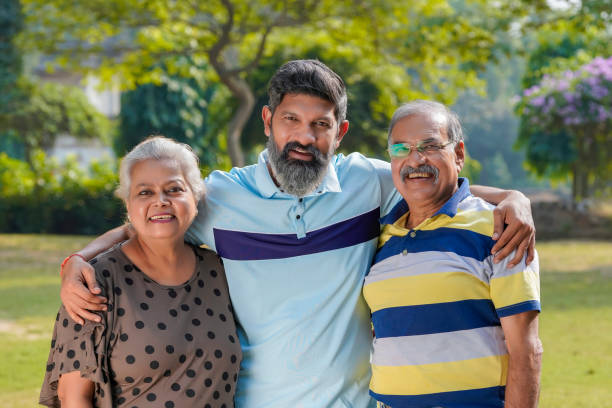Young Indian man with his parents at park