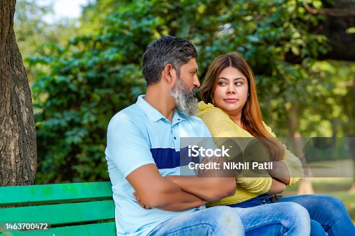istock Indian couple giving angry expression at park. 1463700472
