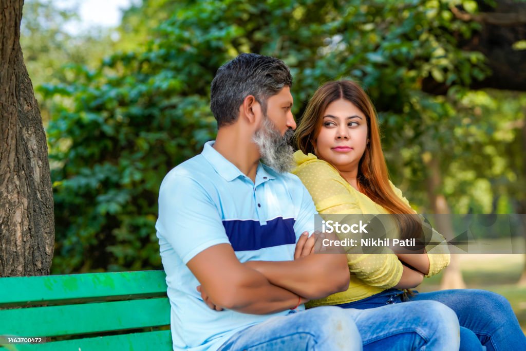 Indian couple giving angry expression at park. Couple - Relationship Stock Photo