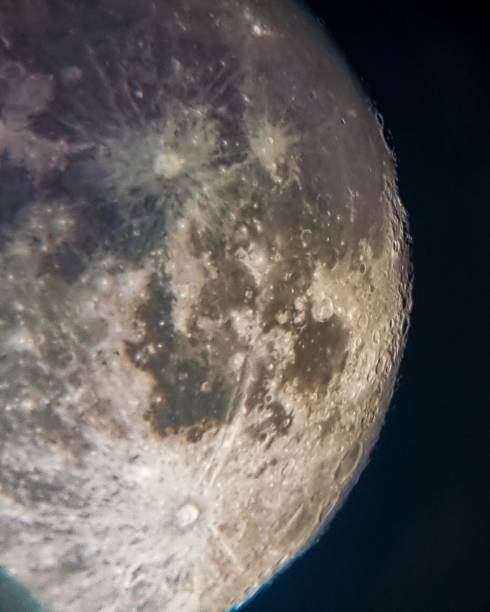 istock Vertical shot of the full moon on the black background 1463701146
