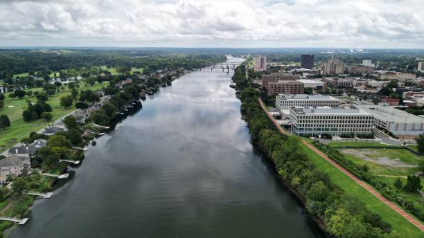 istock Bird's eye view of a river flowing between residential districts 1463703145