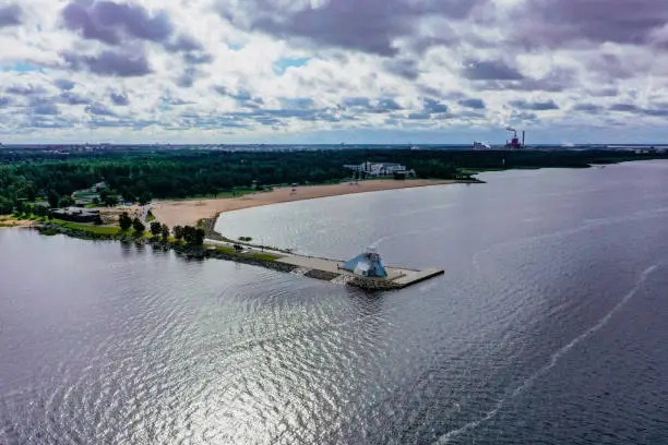 Aerial drone view over the Nallikari lighthouse, beach and the Eden spa, in Oulu, Finland