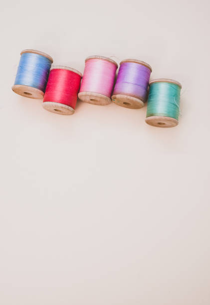 istock Colorful sewing threads on a light background with free space for text 1463705279
