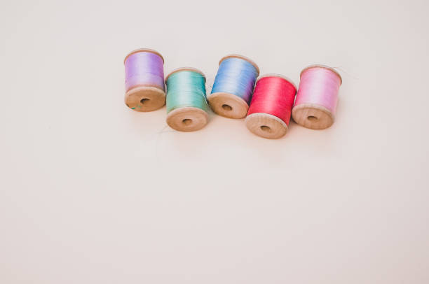 istock Colorful sewing threads on a light background with free space for text 1463705294