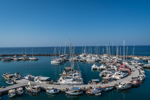 Vlichada beach bay, Santorini, Greece - August 2022 : Panoramic view of the port with yachts and boats moored to shore