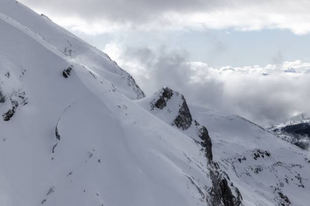 istock Real huge avalanche comes from a big mountain against a cloudy sky 1463707548