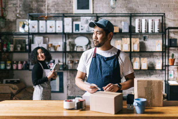 Coffee shop owner packs a box of his freshly roasted coffee stock photo