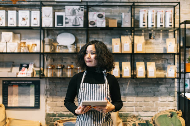 istock Coffee roastery owner using digital tablet in her coffee shop 1463708712