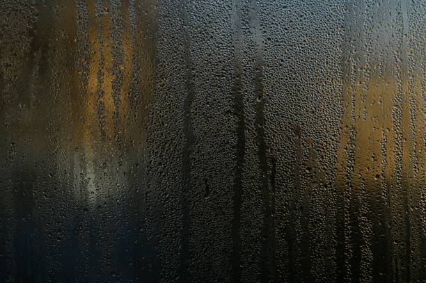 istock water flows on the glass. condensation drops on the window. 1463709121