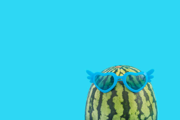istock Fun blue background with a watermelon wearing sunglasses 1463709473