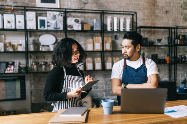 istock Small business owners working behind cafe counter 1463709562