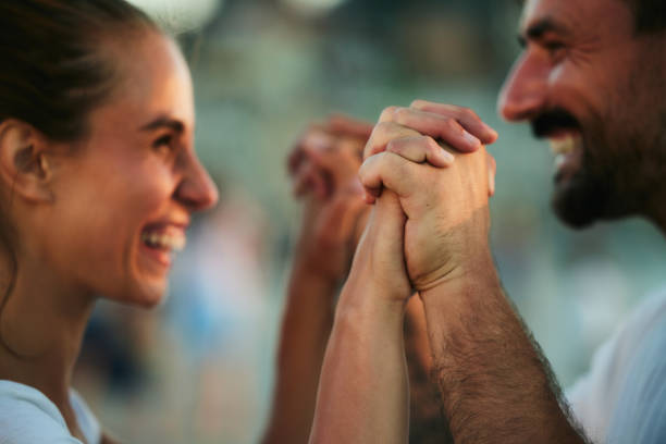 Close up of happy couple holding hands and talking.