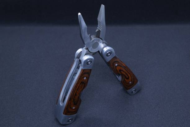istock Closeup of Multi tool tweezers in black background 1463710373