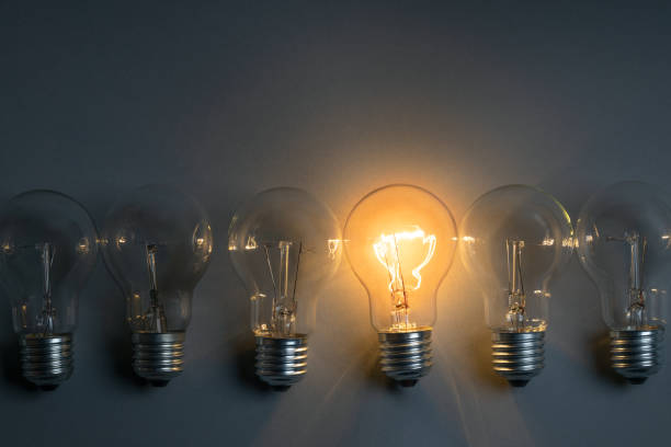 istock Idea concept with classic light bulb glowing in the dark 1463712908