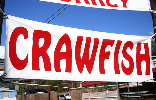 A closeup of a crawfish sign of a rural food stand