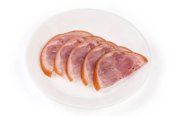 istock Sliced boiled-smoked pork knuckle on a white plate 1463713208