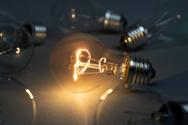 istock Idea concept with classic light bulb glowing in the dark 1463713456