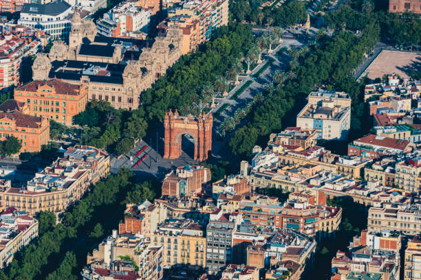Aerial view of Passeig Lluís Companys with the Arch de Triunfo and with the typical buildings of Barcelona cityscape from helicopter. top view Aerial view of Passeig Lluís Companys with the Arch de Triunfo and with the typical buildings of Barcelona cityscape from helicopter. top view arc de triomf barcelona photos stock pictures, royalty-free photos & images