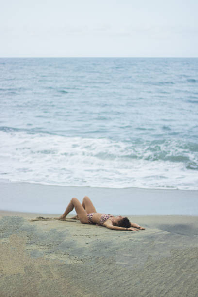 istock Beautiful female in a bikini on a tropical beach 1463714359