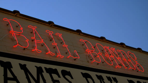 istock Glowing neon red sign on a building saying 