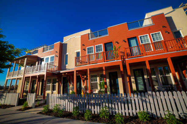 istock Low angle view of  modern houses with yards and open roofs for rest, and sky above them 1463715986