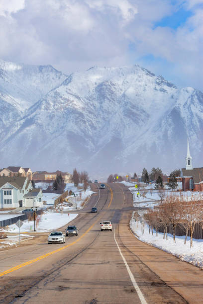 istock Road going toward a mountain through a town on a cloudy day 1463716109