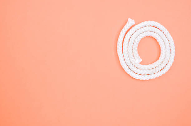 istock Closeup shot of a rope on an orange surface - copy space 1463721017