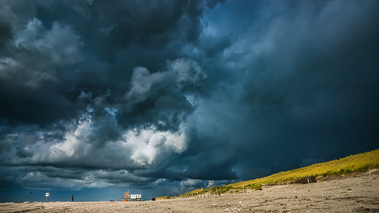 A closeup shot of details of a threatening summer storm on the sandy beaches of the Dutch coast