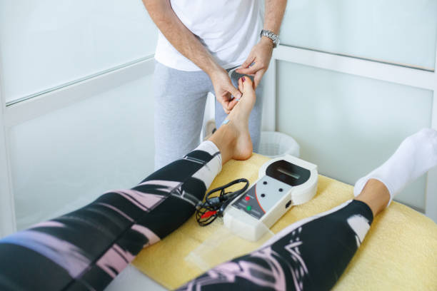 istock Preparing patient's foot for electrotherapy treatment 1463721965