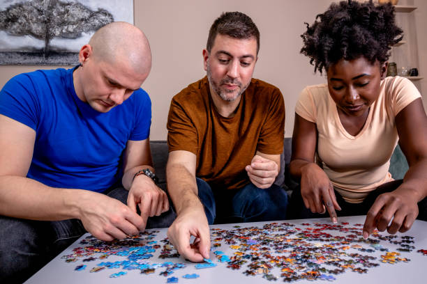 istock Friends playing jigsaw puzzles at home. 1463722659