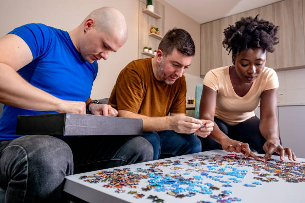 istock Friends playing jigsaw puzzles at home. 1463723451