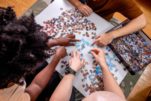 istock Family playing jigsaw puzzle game at home. 1463723623