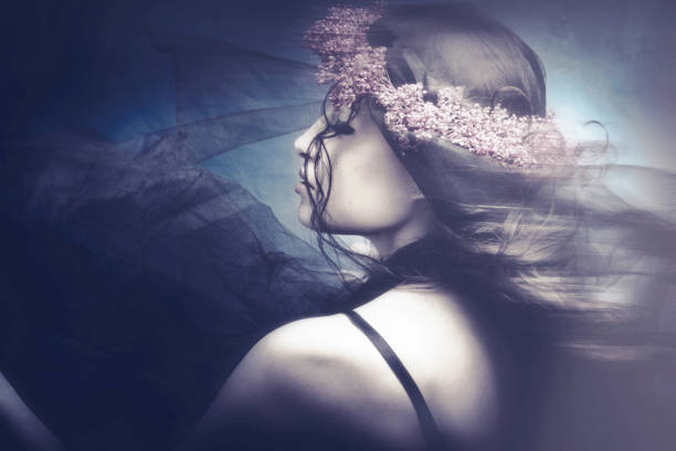 beautiful woman dancing with black veil and wreath of flowers in hair