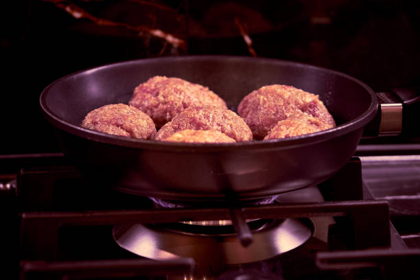 meat cutlets are fried in a frying pan in the kitchen