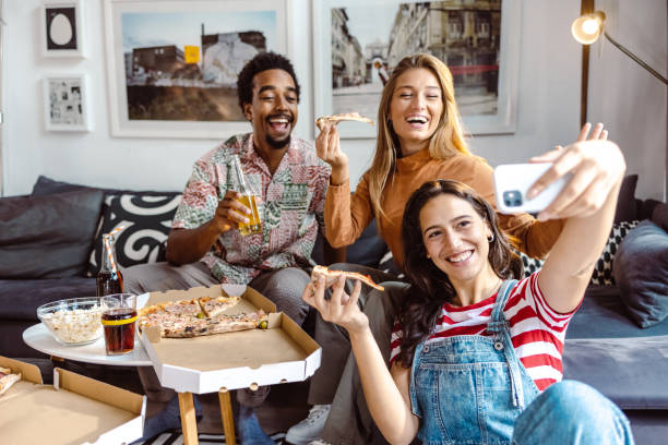 istock Small group of friends taking selfie at home 1463731325