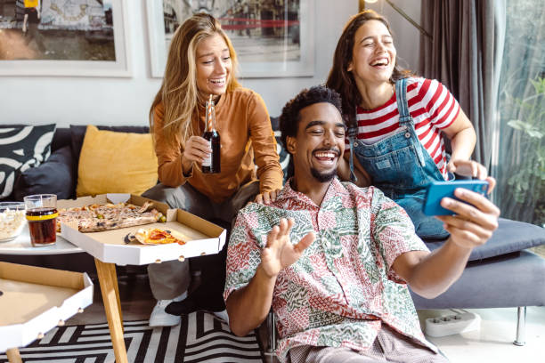 istock Multiethnic group of friends taking selfie at home 1463731355