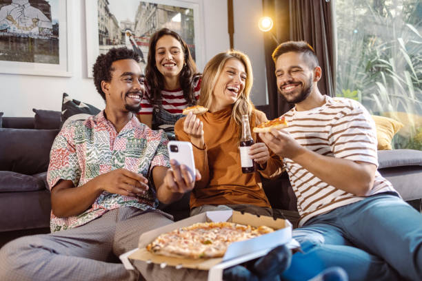 istock Group of young people hanging out at home and using smart phone 1463735559