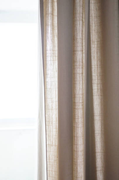 istock Vertical shot of curtains in front of a window 1463741028