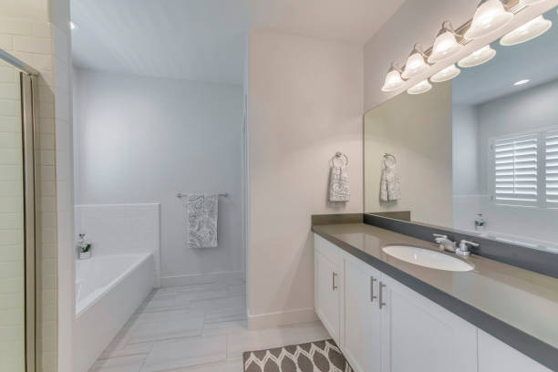 istock Mirror, a sink, and a bath in a bathroom 1463743906