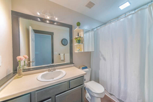 istock Mirror, a sink, and a bath with closed curtains in a bathroom 1463743918