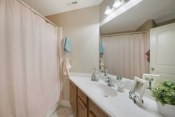 istock Mirror, a sink, and a bath with a closed curtain in a bathroom 1463743967